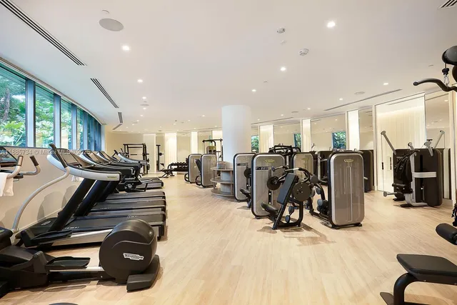 a view of a patio with a table and chairs under an umbrella
