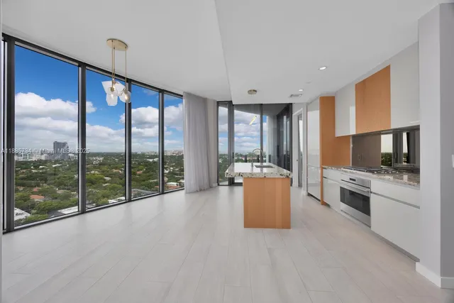 a view of a hallway with wooden floor and cabinet