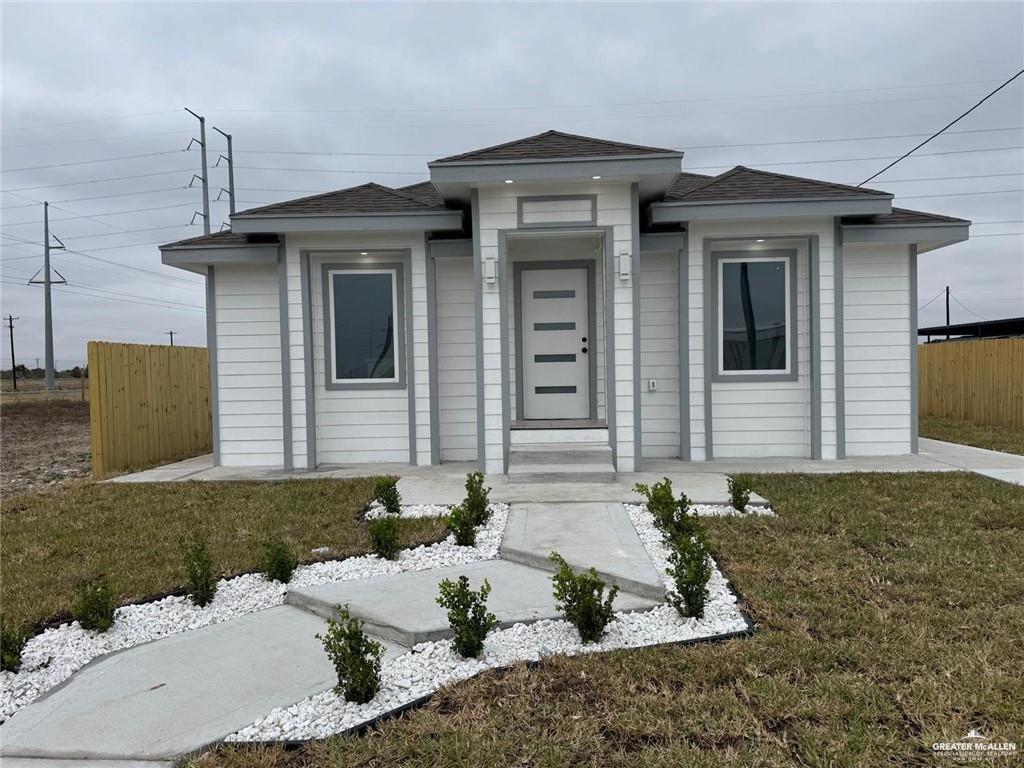 7513 Aztec Street Donna, TX 78537 - Photo 1 of 15 a front view of a house with garden