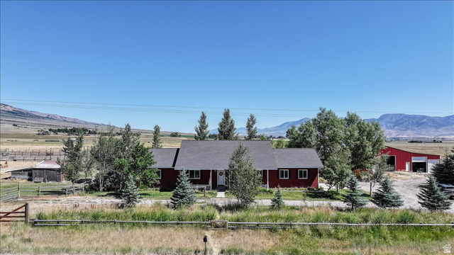 1634 West Arimo Road Arimo, ID 83214 - Photo 89 of 89 Red single-story residence featuring a dark shingle roof and white trim