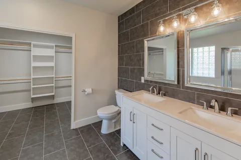 a bathroom with a sink vanity and toilet