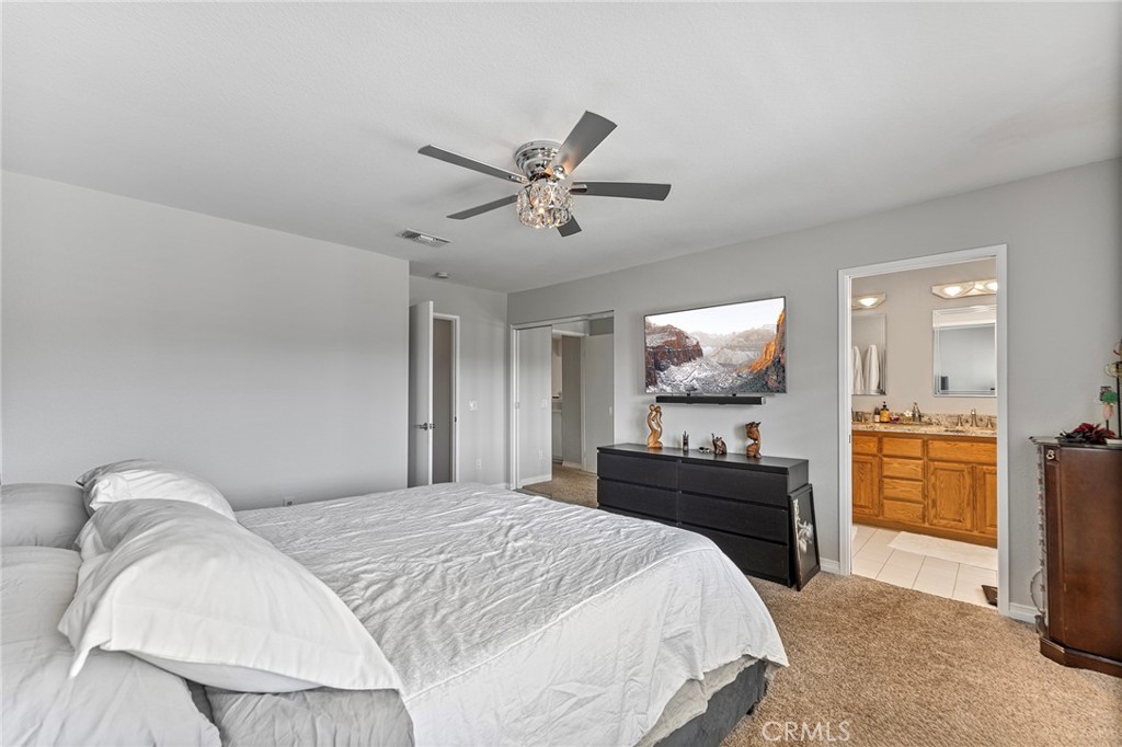 15 Ravencrest Circle Phillips Ranch, CA 91766 - Photo 11 of 22 a bedroom with a bed and a chandelier
