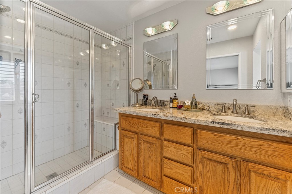 15 Ravencrest Circle Phillips Ranch, CA 91766 - Photo 12 of 22 a bathroom with a granite countertop sink mirror and double