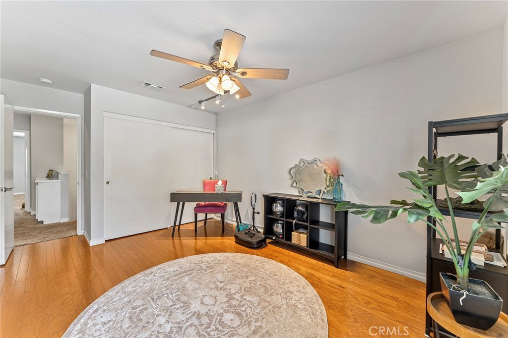 15 Ravencrest Circle Phillips Ranch, CA 91766 - Photo 14 of 22 a living room with fireplace furniture and a wooden floor