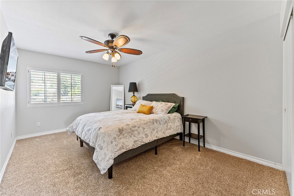 15 Ravencrest Circle Phillips Ranch, CA 91766 - Photo 15 of 22 a bedroom with a bed and a chandelier
