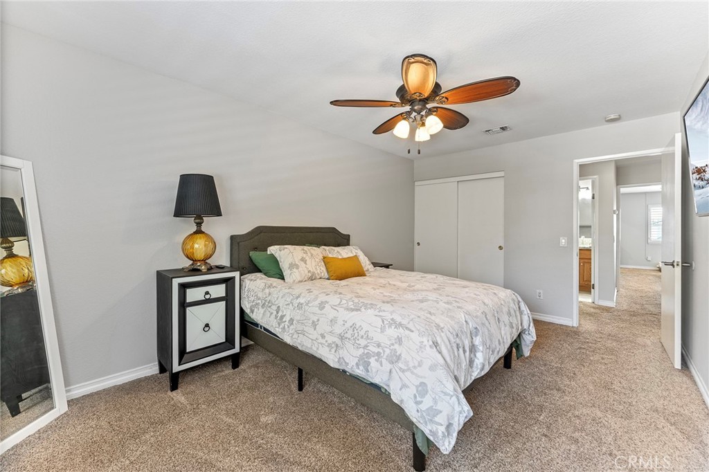 15 Ravencrest Circle Phillips Ranch, CA 91766 - Photo 16 of 22 a bedroom with a bed and a chandelier