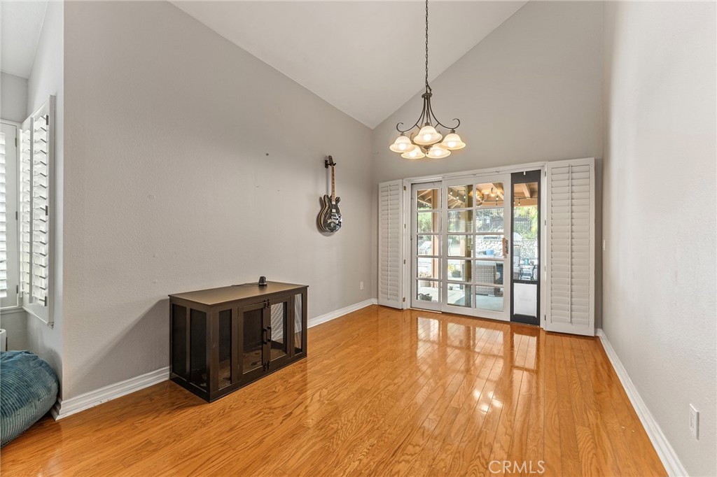 15 Ravencrest Circle Phillips Ranch, CA 91766 - Photo 4 of 22 a view of an empty room with wooden floor and a window