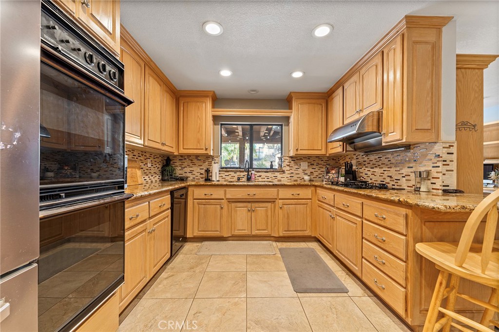 15 Ravencrest Circle Phillips Ranch, CA 91766 - Photo 6 of 22 a kitchen with stainless steel appliances granite countertop a sink and cabinets
