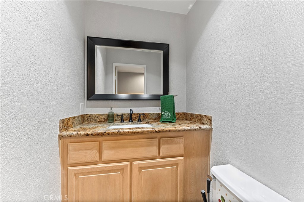 15 Ravencrest Circle Phillips Ranch, CA 91766 - Photo 9 of 22 a bathroom with a granite countertop sink vanity and mirror