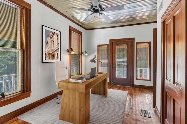 a view of a hallway with furniture and windows