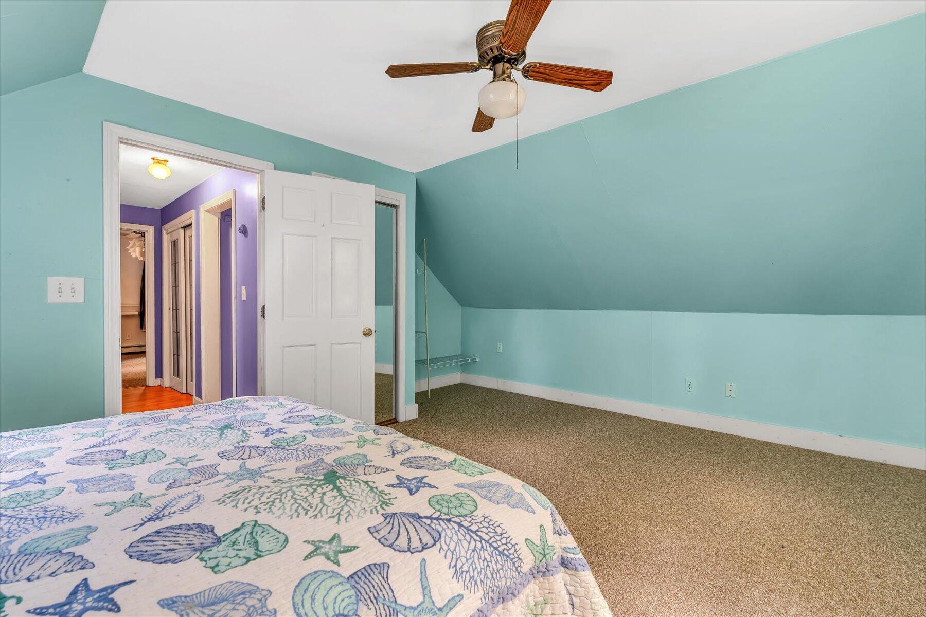 80 Curlew Way Cotuit, MA 02635 - Photo 22 of 37 a bedroom with a bed and a chandelier