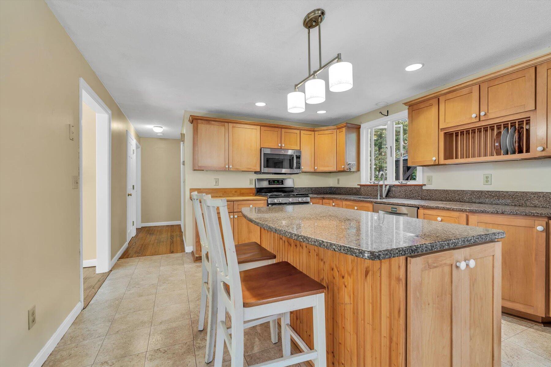 80 Curlew Way Cotuit, MA 02635 - Photo 9 of 37 a kitchen with stainless steel appliances granite countertop a sink a stove and a refrigerator