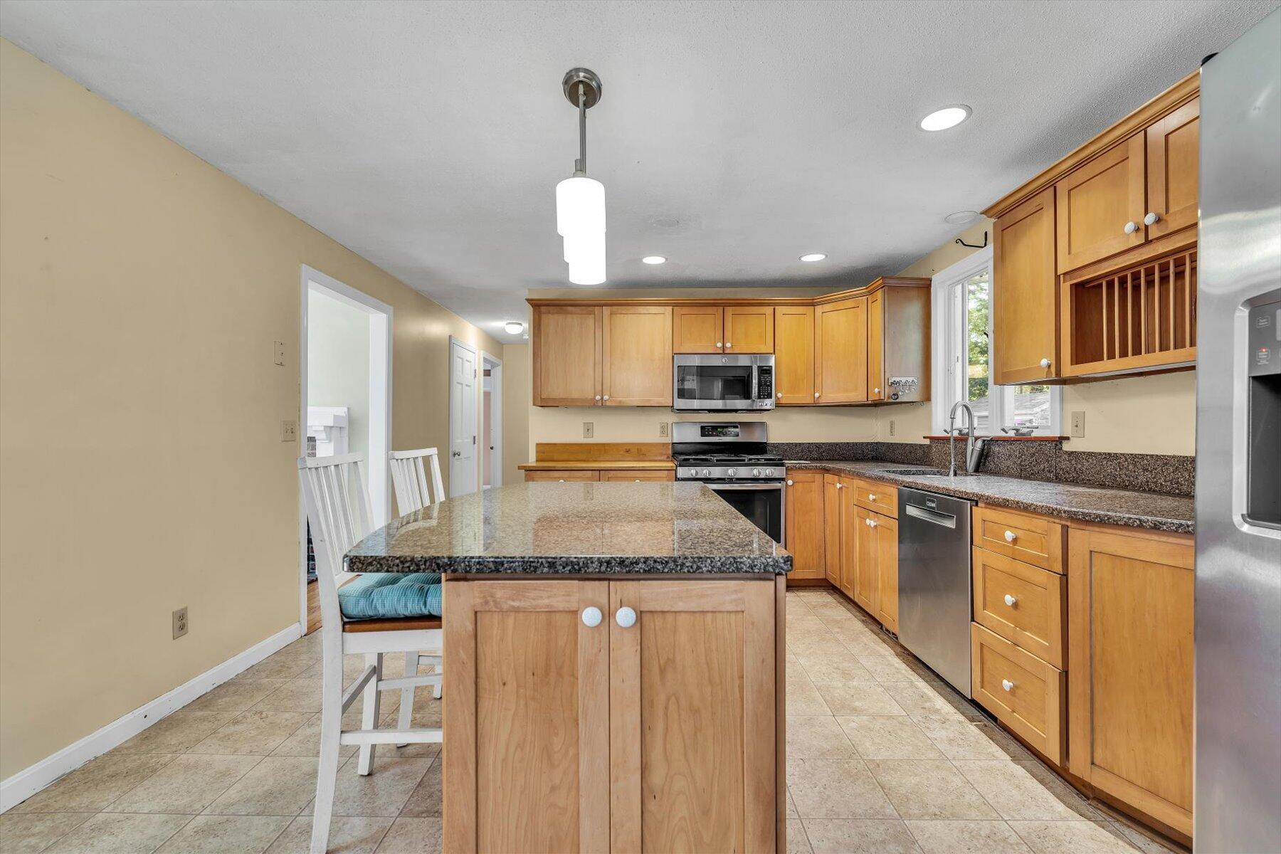80 Curlew Way Cotuit, MA 02635 - Photo 10 of 37 a kitchen with stainless steel appliances granite countertop a sink counter space cabinets and a large window