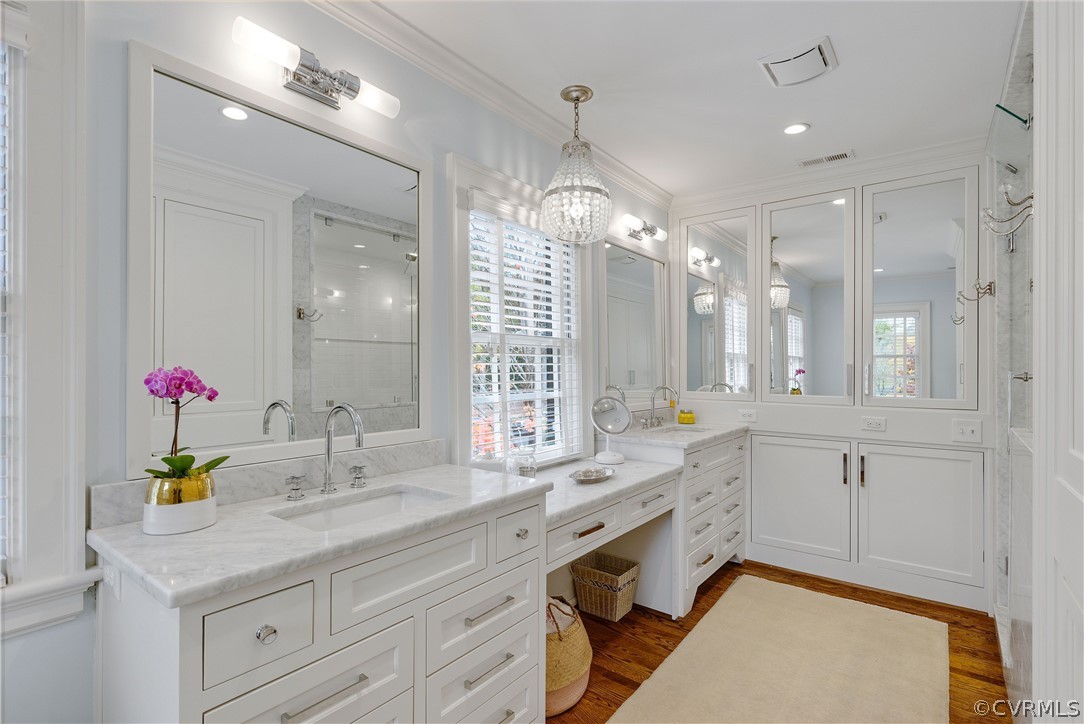 109 Nottingham Road Richmond, VA 23221 - Photo 23 of 44 Luxurious primary bath with separate vanities, large marble shower; door beneath mirrored cabinets is hidden pass-through to laundry room