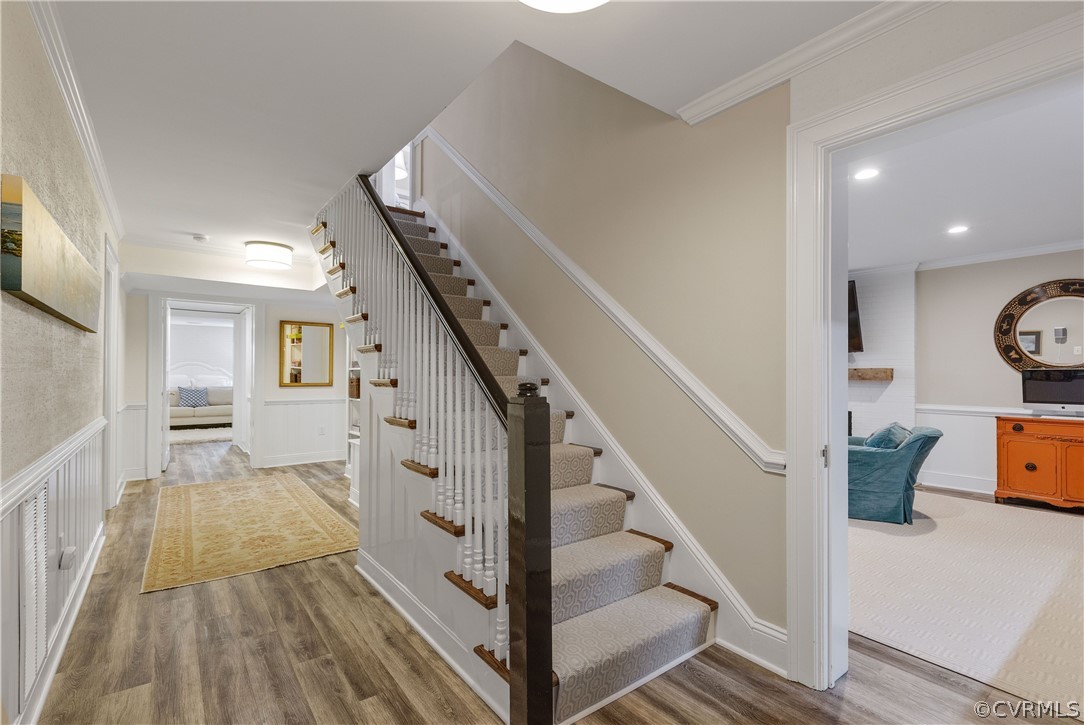 109 Nottingham Road Richmond, VA 23221 - Photo 32 of 44 Staircase to lower level with wainscoting and LVP flooring throughout