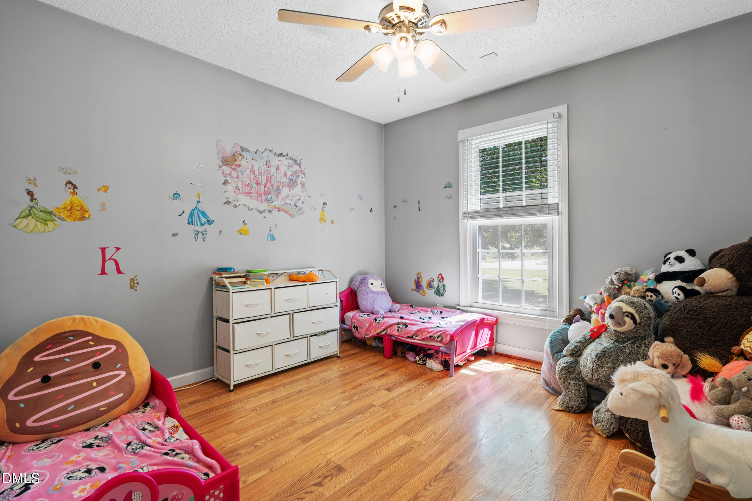 311 Bridgers Road Kenly, NC 27542 - Photo 20 of 46 a bedroom with a bed and a chandelier