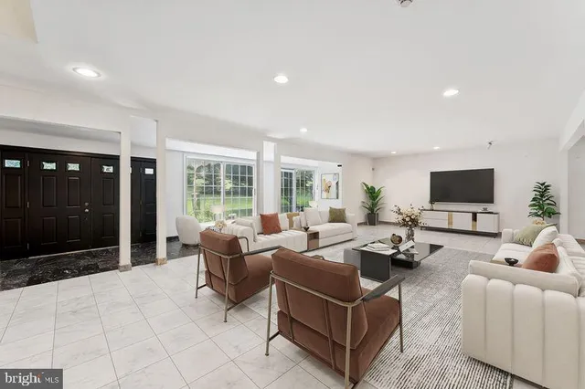 a living room with furniture or stairs and a view of kitchen