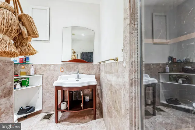 a spacious bedroom with a bed and a chandelier