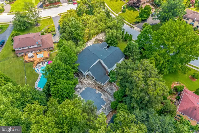 an aerial view of a house with garden space and street view