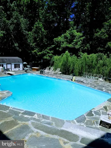 a view of a swimming pool with an outdoor space and seating area