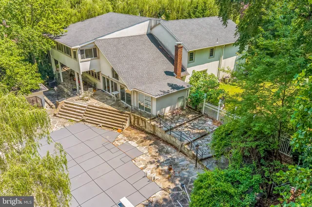 an aerial view of a house with a yard and potted plants