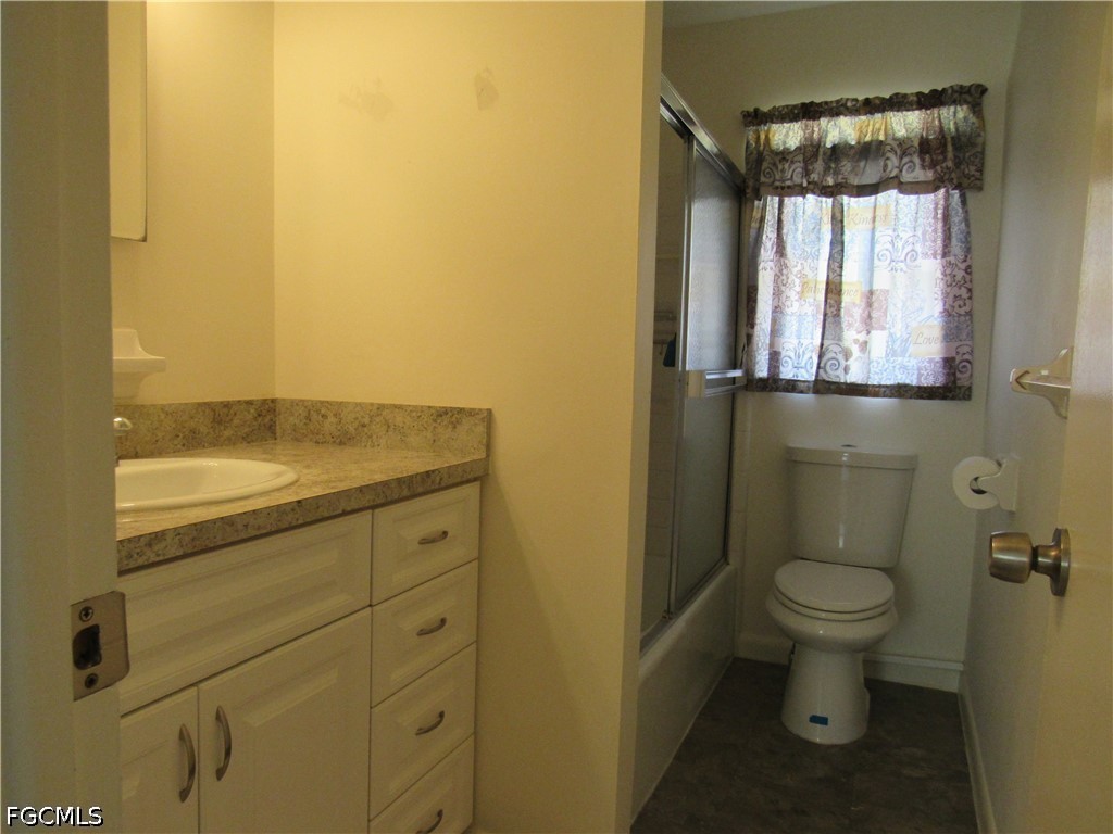 2976 Ribbon Court Fort Myers, FL 33905 - Photo 12 of 16 a bathroom with a granite countertop toilet and a sink