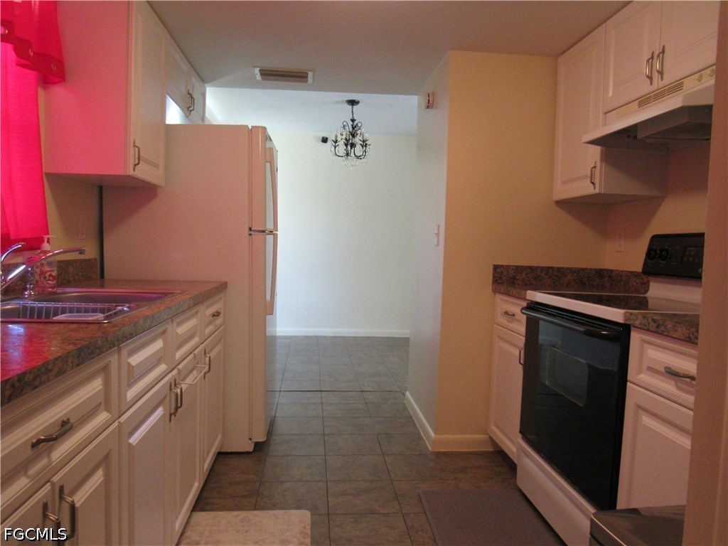 2976 Ribbon Court Fort Myers, FL 33905 - Photo 4 of 16 a kitchen with stainless steel appliances a stove and a refrigerator