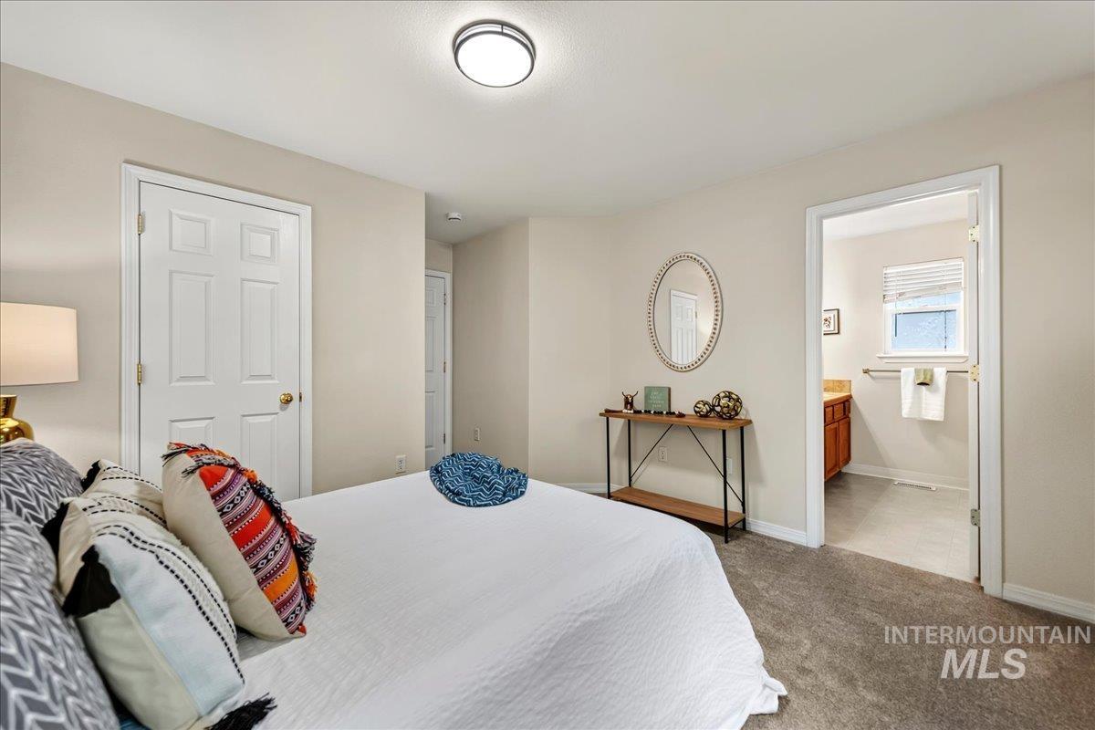 2356 West Hill Road Boise, ID 83702 - Photo 14 of 22 Neutral wall color, carpeted flooring, white paneled door, flush-mount ceiling light, and access to an adjoining bathroom