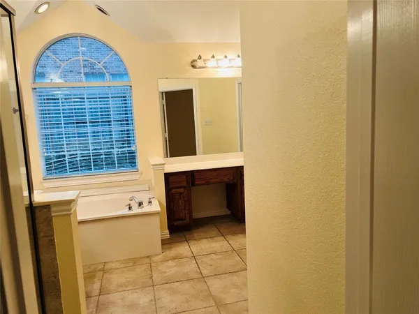 a bathroom with a bathtub and a window