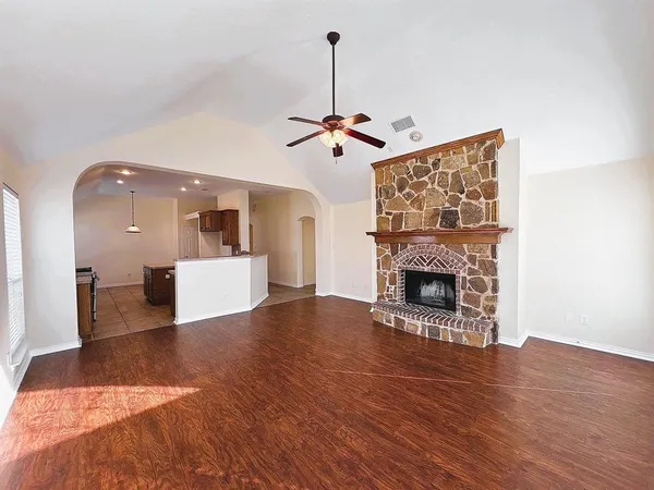 a view of a livingroom with a fireplace a chandelier a wooden table and chandelier