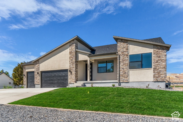 2503 North Scarlet Road, Unit 252 Eagle Mountain, UT 84005 - Photo 2 of 17 Contemporary exterior featuring stacked stone accents, stucco siding, and a dark asphalt shingle roof