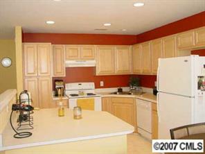 11612 Rabbit Ridge Road, Unit 11612 Charlotte, NC 28270 - Photo 4 of 8 a kitchen with a sink a stove and white cabinets