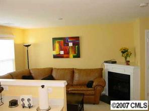 11612 Rabbit Ridge Road, Unit 11612 Charlotte, NC 28270 - Photo 5 of 8 a living room with a fireplace and a table