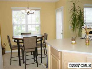 11612 Rabbit Ridge Road, Unit 11612 Charlotte, NC 28270 - Photo 6 of 8 a view of a dining room with furniture and chandelier