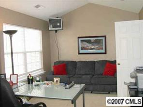 11612 Rabbit Ridge Road, Unit 11612 Charlotte, NC 28270 - Photo 7 of 8 a living room with furniture and a window