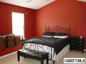 11612 Rabbit Ridge Road, Unit 11612 Charlotte, NC 28270 - Photo 8 of 8 a bedroom with a bed and a chandelier