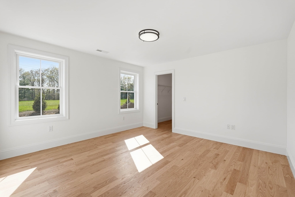 16 Couture Way Middleton, MA 01949 - Photo 30 of 36 an empty room with wooden floor and windows