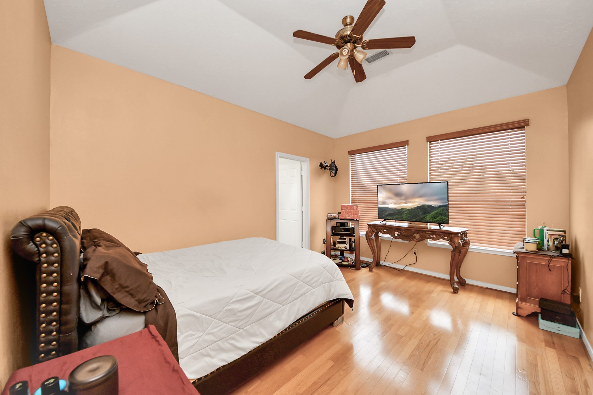23814 Spring Dane Drive Spring, TX 77373 - Photo 24 of 41 a bedroom with a bed a flat screen tv and couches