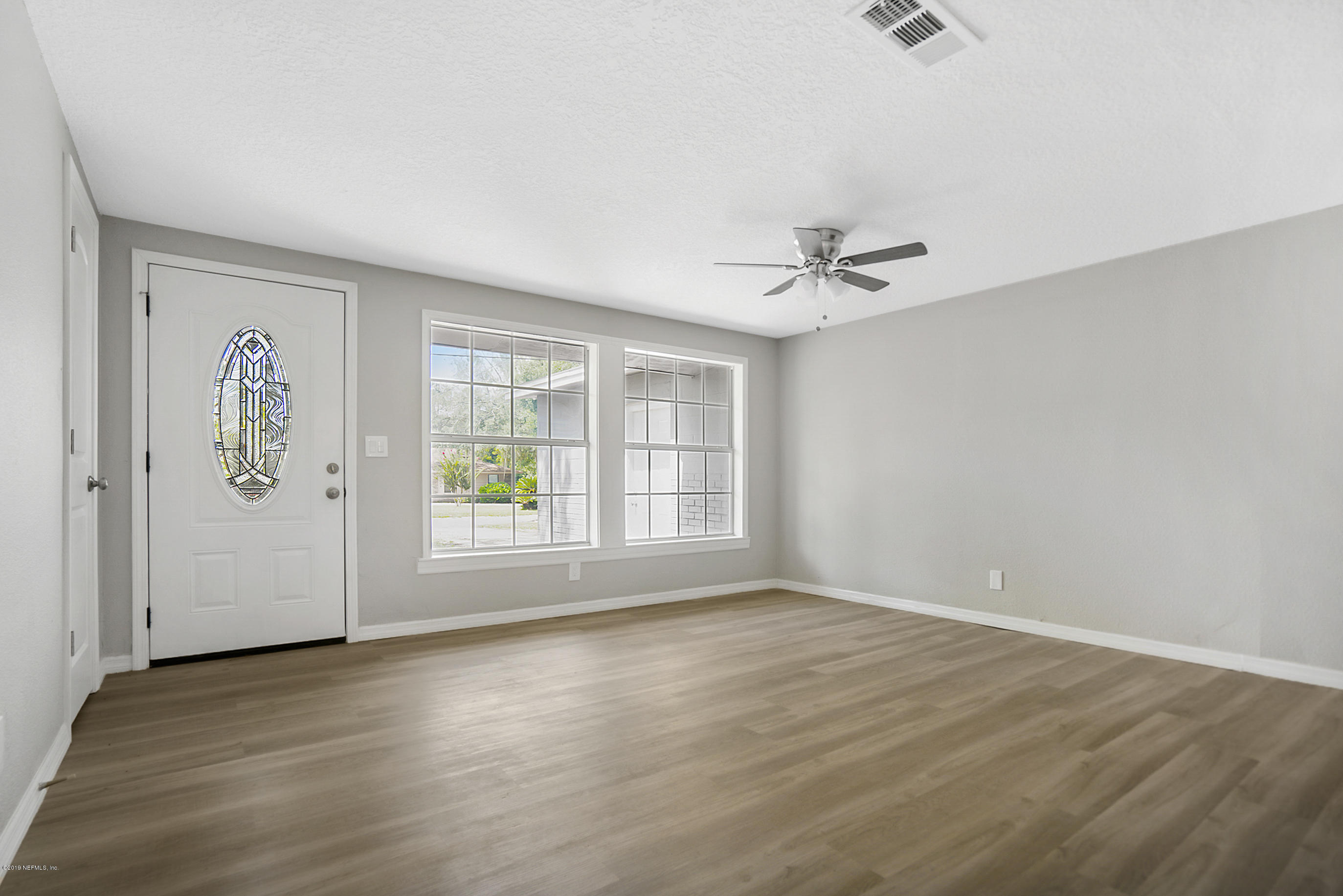 10483 Tulsa Road Jacksonville, FL 32218 - Photo 26 of 30 wooden floor in an empty room with a window