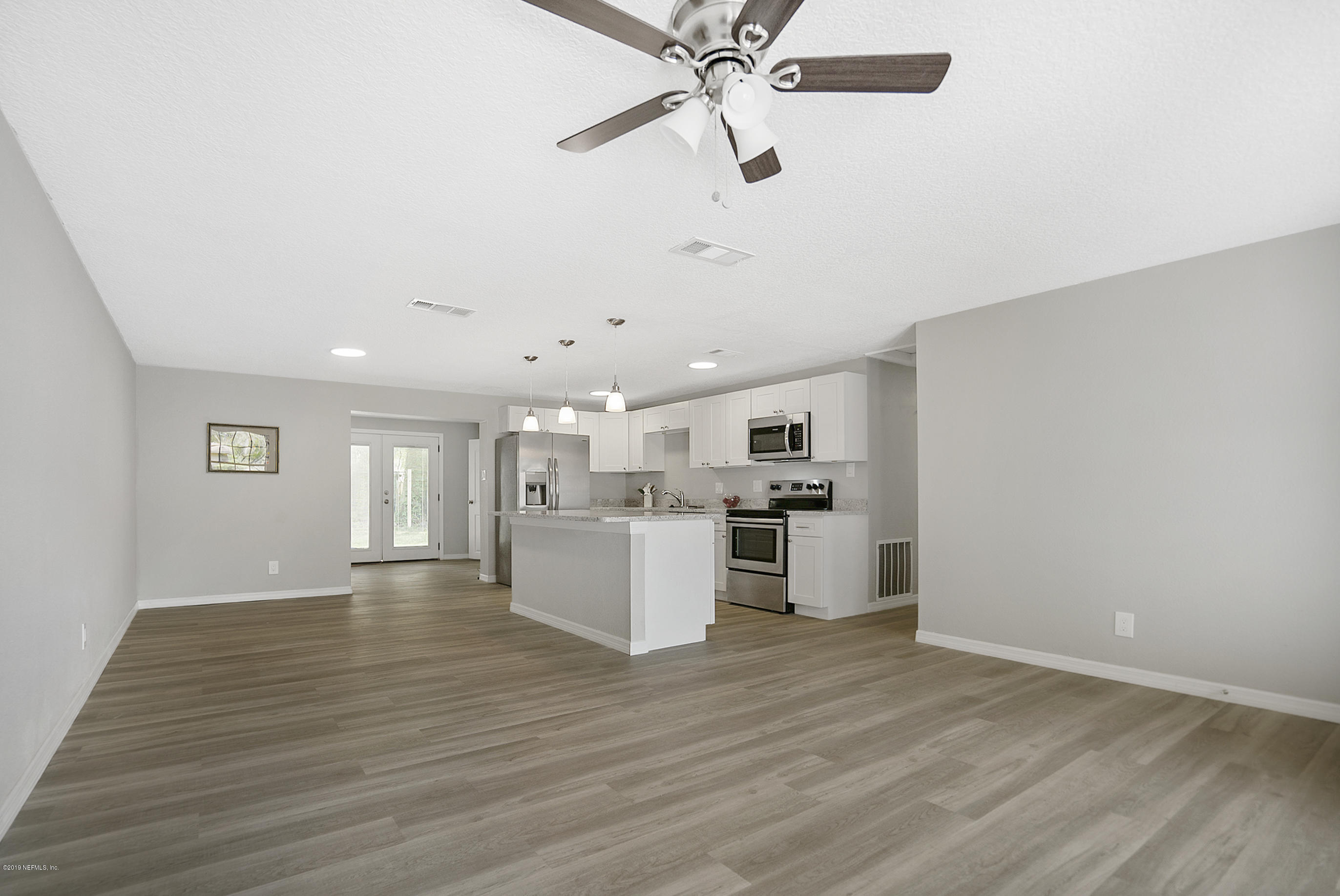 10483 Tulsa Road Jacksonville, FL 32218 - Photo 27 of 30 a view of a kitchen with a sink and a refrigerator