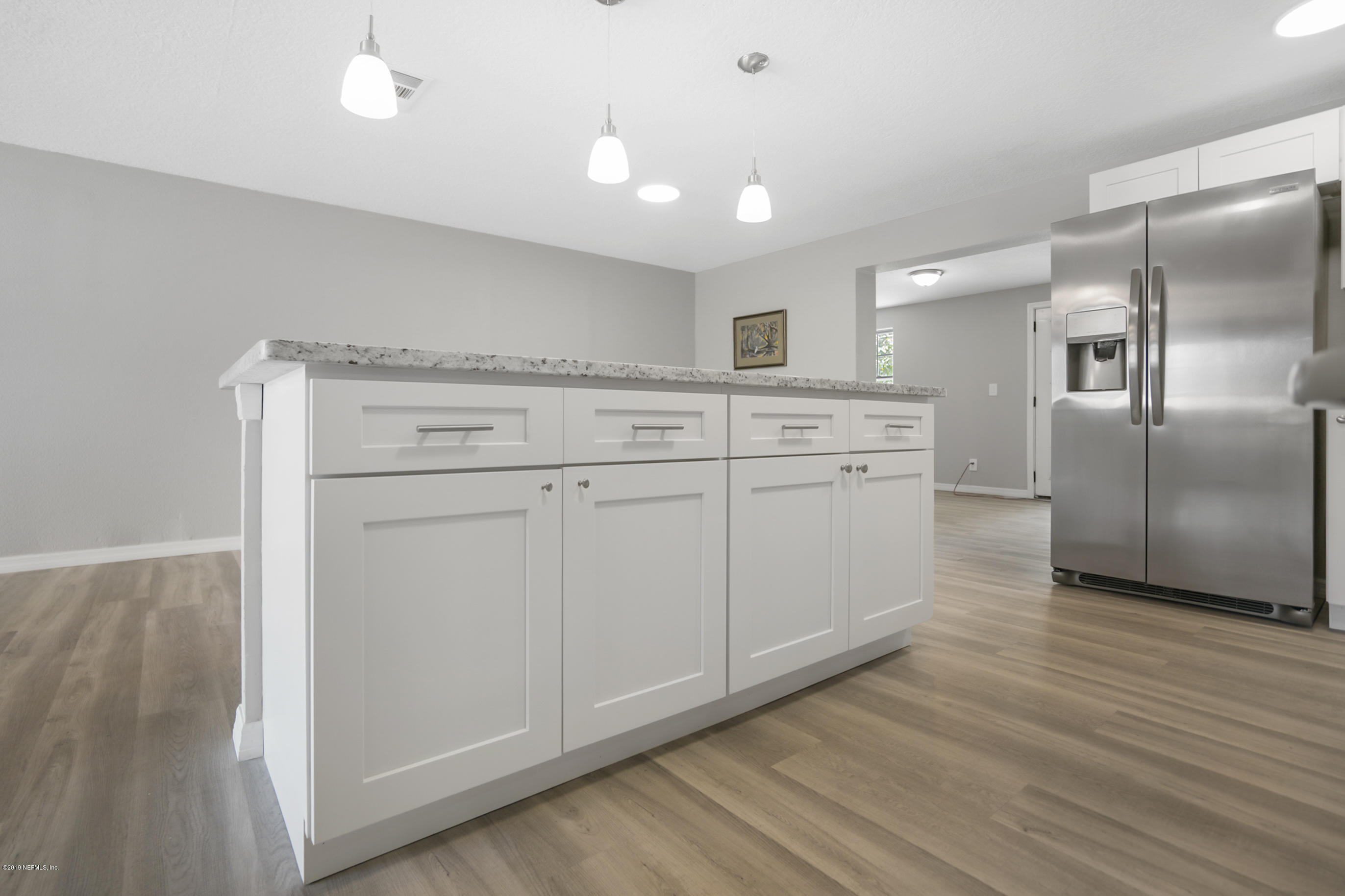 10483 Tulsa Road Jacksonville, FL 32218 - Photo 7 of 30 a kitchen with white cabinets and stainless steel appliances