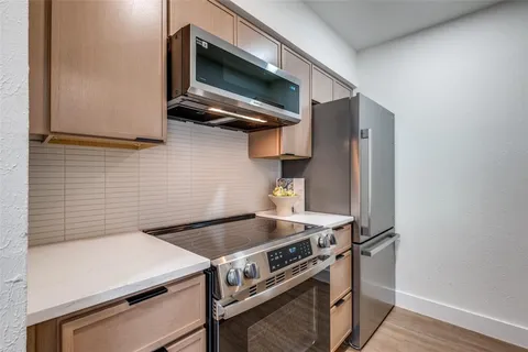 a stove top oven sitting inside of a kitchen