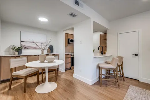a view of a room with furniture and wooden floor