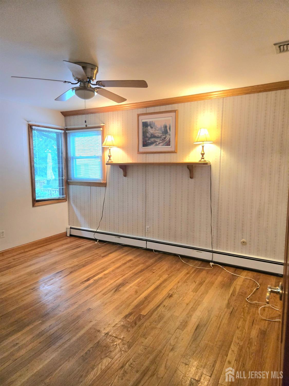 937 North Concourse Keyport, NJ 07735 - Photo 17 of 27 an empty room with wooden floor fan and windows