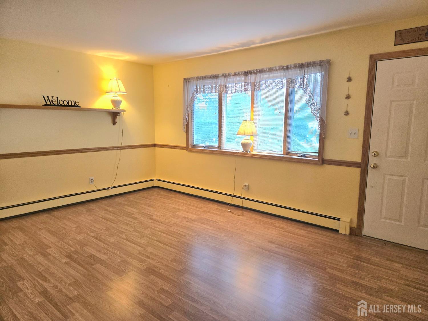 937 North Concourse Keyport, NJ 07735 - Photo 9 of 27 a view of an empty room with wooden floor and a window