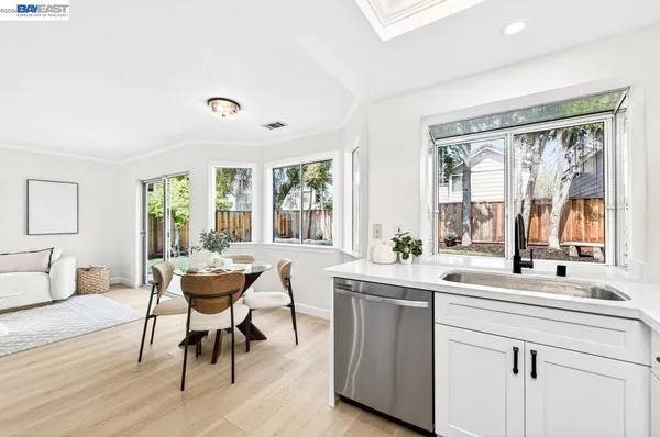 a view of a a dining room with furniture window and wooden floor