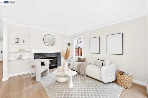 a living room with furniture a fireplace and a large mirror