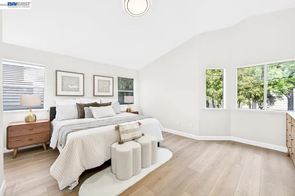 a bed room with a bed and a large window