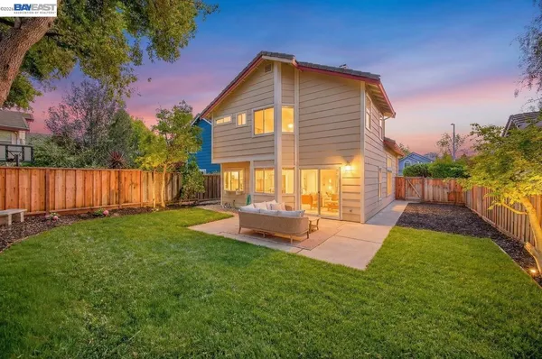 a backyard of a house with table and chairs