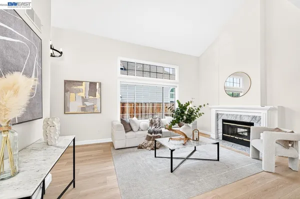 a living room with furniture a rug and a fireplace